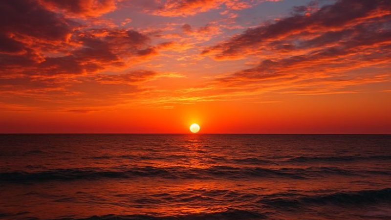 🌅 Sunset Serenity 🌊 A breathtaking golden hour moment where the sky bursts into fiery shades_